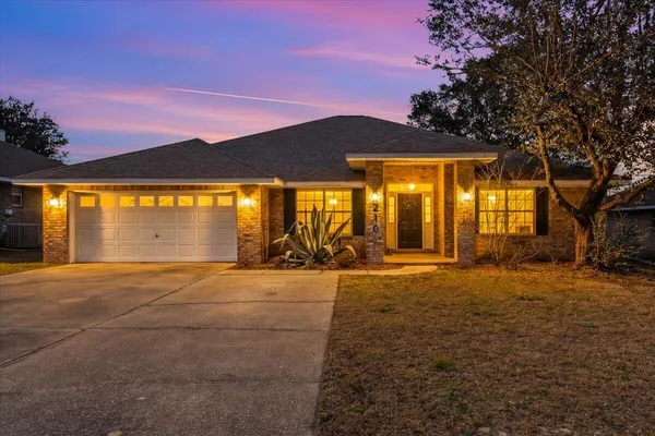 a view of an empty room with a floor to ceiling window and a yard