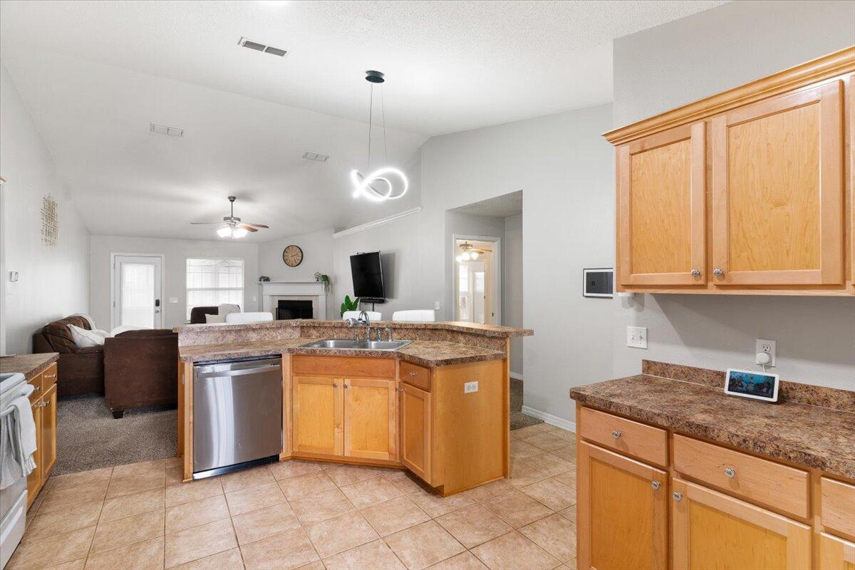 210 Citadel Lane Crestview, FL 32539 - Photo 12 of 38 a kitchen with stainless steel appliances granite countertop a sink and cabinets