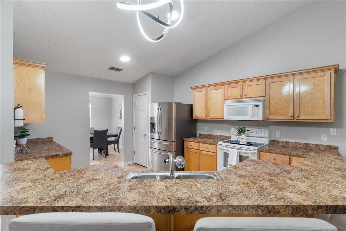 210 Citadel Lane Crestview, FL 32539 - Photo 15 of 38 a kitchen with stainless steel appliances granite countertop a sink refrigerator and stove