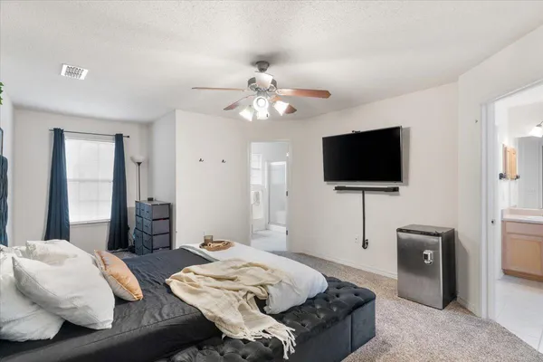 a bedroom with furniture and a flat screen tv