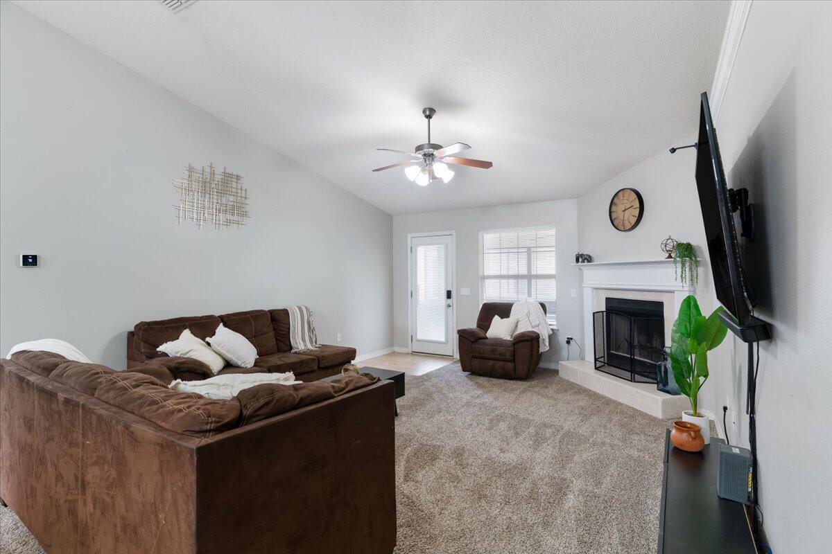 210 Citadel Lane Crestview, FL 32539 - Photo 23 of 38 a living room with furniture and a fireplace