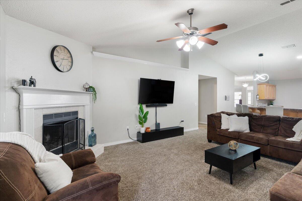 210 Citadel Lane Crestview, FL 32539 - Photo 25 of 38 a living room with furniture a fireplace and a flat screen tv