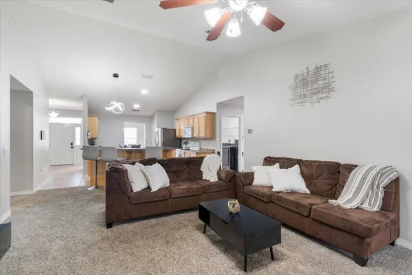 a living room with furniture and a chandelier