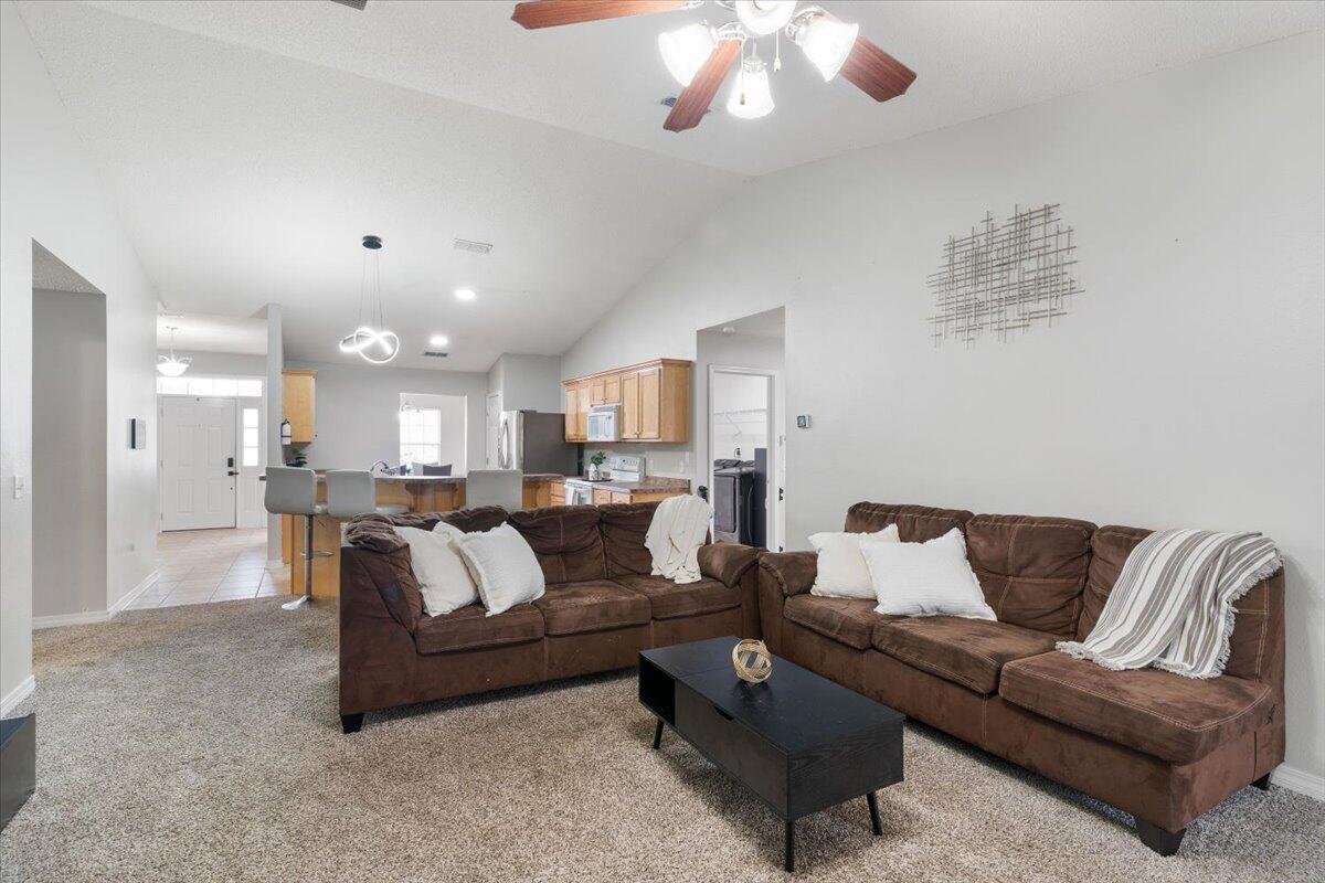 210 Citadel Lane Crestview, FL 32539 - Photo 26 of 38 a living room with furniture and a chandelier