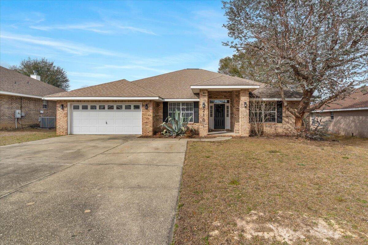210 Citadel Lane Crestview, FL 32539 - Photo 3 of 38 a view of a white house with a large tree