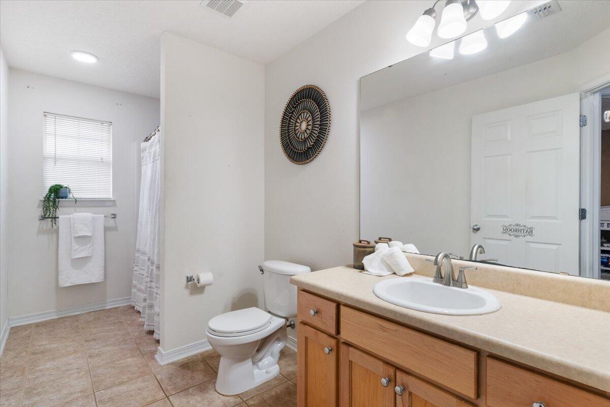 210 Citadel Lane Crestview, FL 32539 - Photo 32 of 38 a bathroom with a toilet a sink and mirror