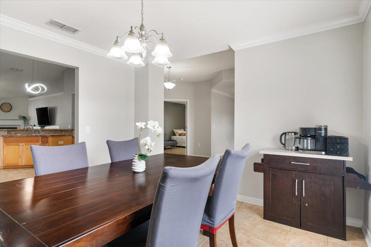 210 Citadel Lane Crestview, FL 32539 - Photo 7 of 38 a view of a dining room with furniture and a chandelier