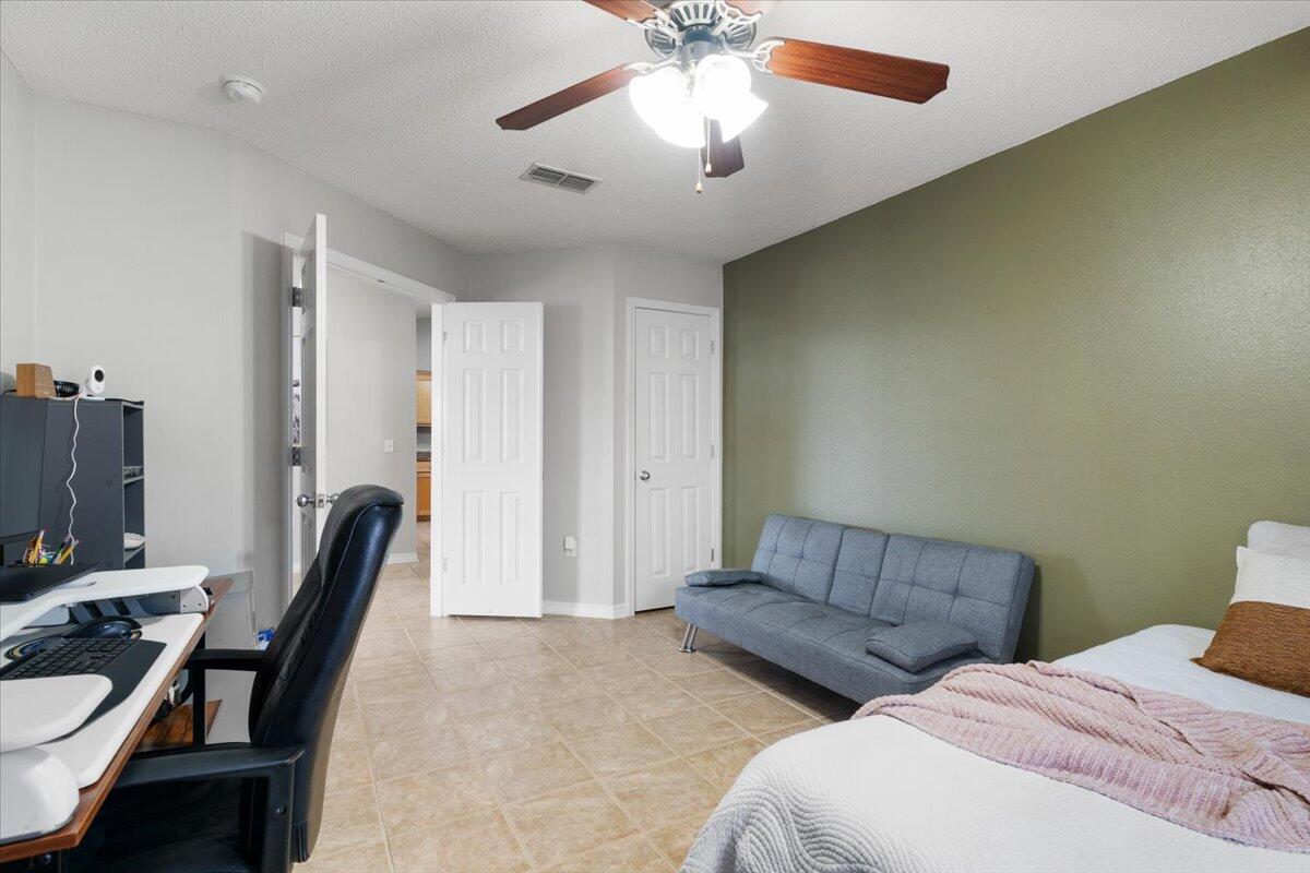 210 Citadel Lane Crestview, FL 32539 - Photo 9 of 38 a bedroom with furniture and a chandelier