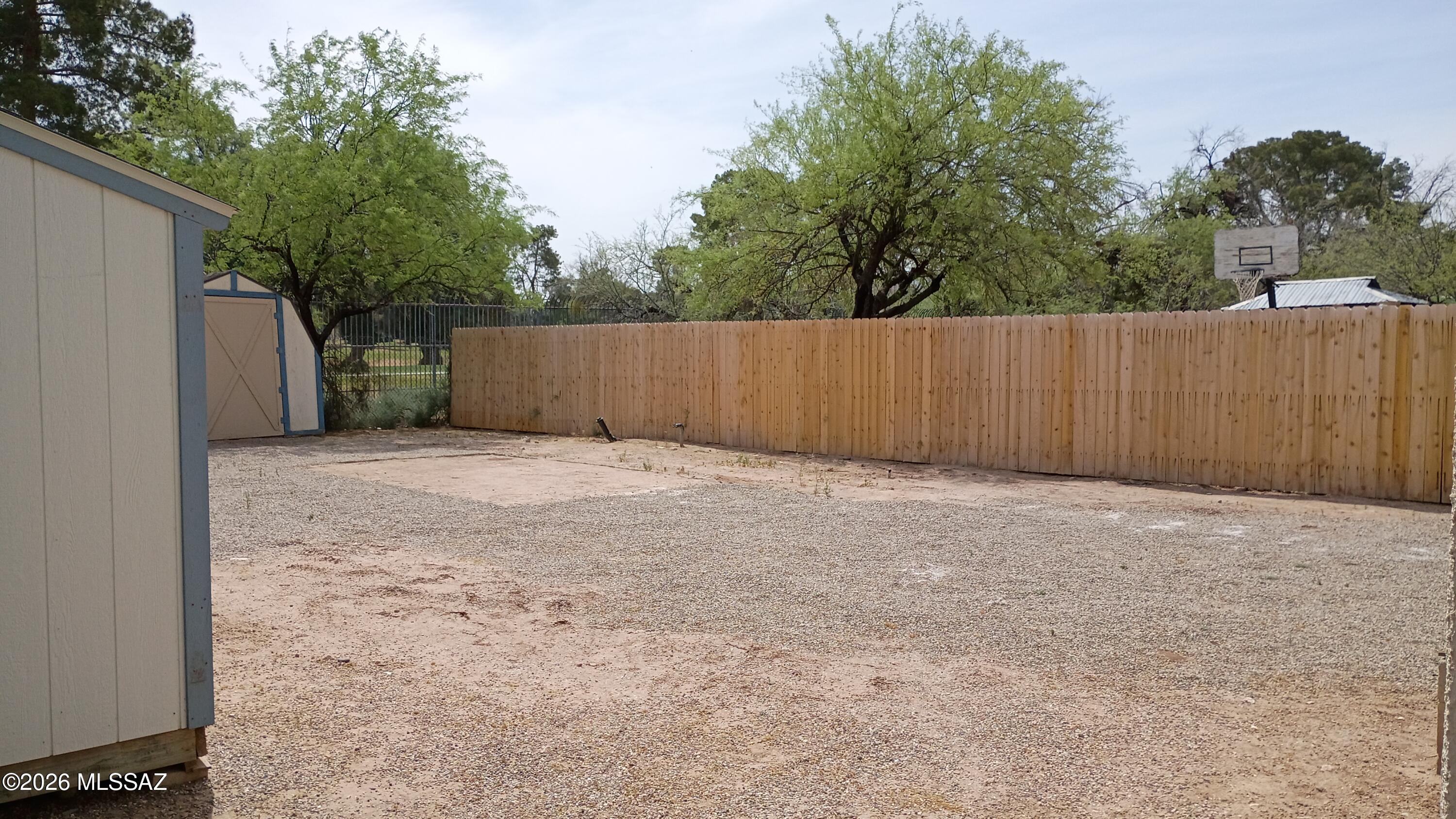 1449 West Hualpai Road Tucson, AZ 85745 - Photo 48 of 49 a view of backyard with small cabin and wooden fence
