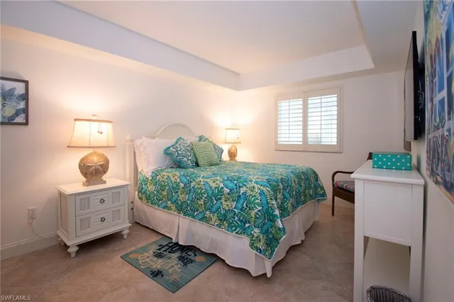 a bedroom with a bed and a dresser in it