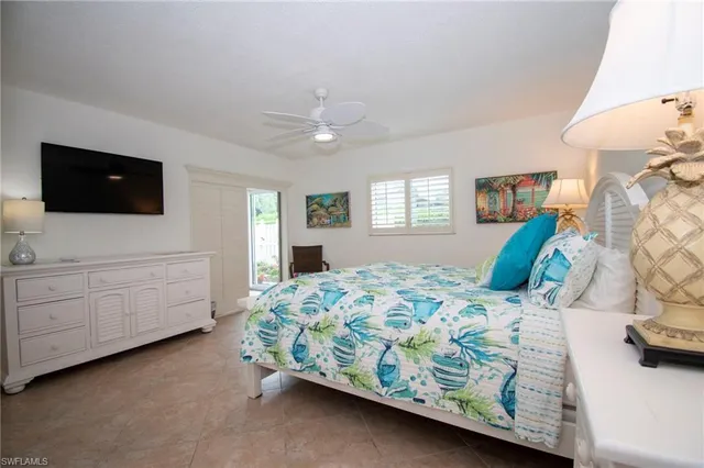 a bedroom with a bed a window and dresser