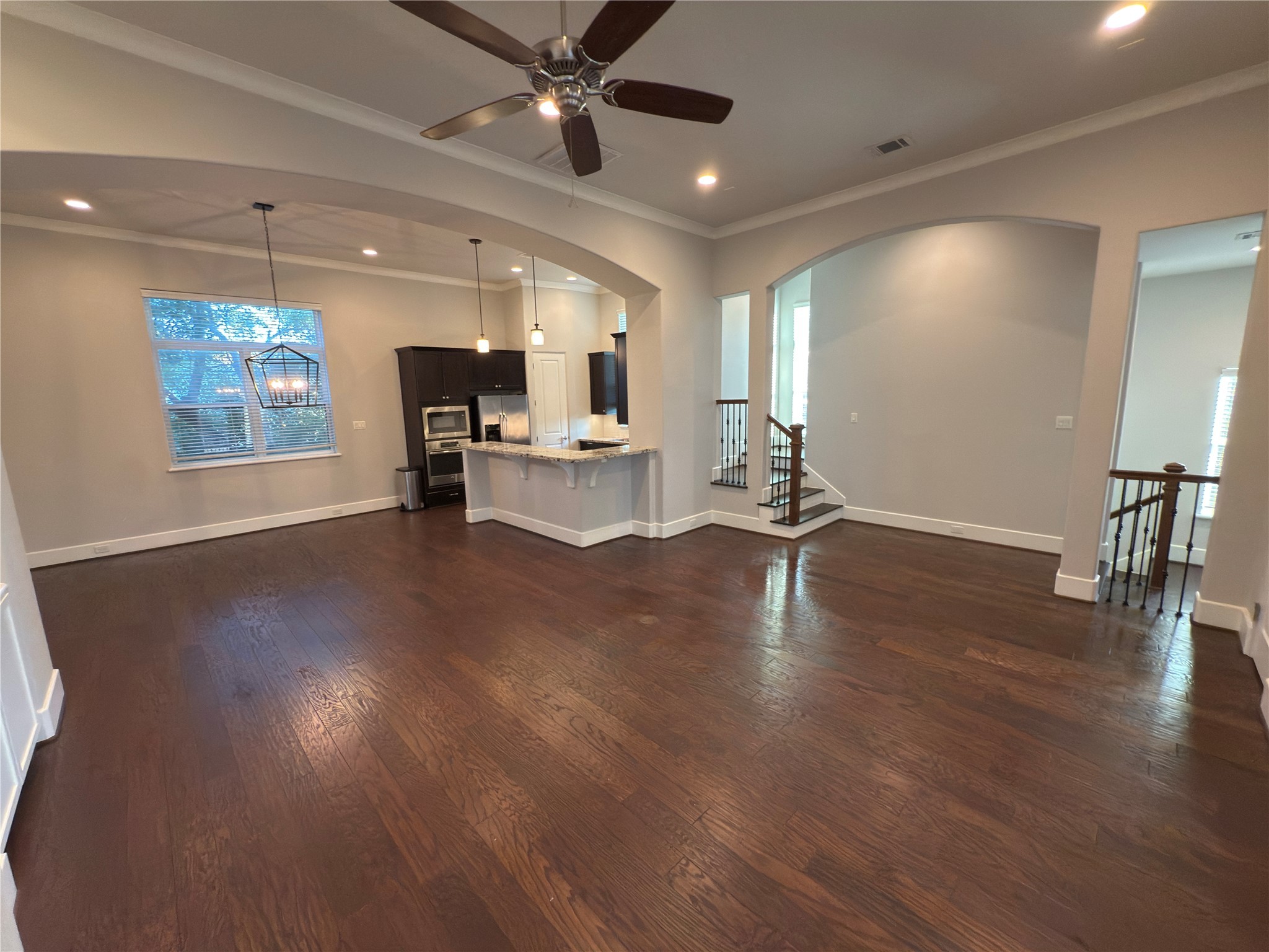 5640 Larkin Street Houston, TX 77007 - Photo 13 of 36 a view of a room with kitchen island stainless steel appliances wooden floor and window