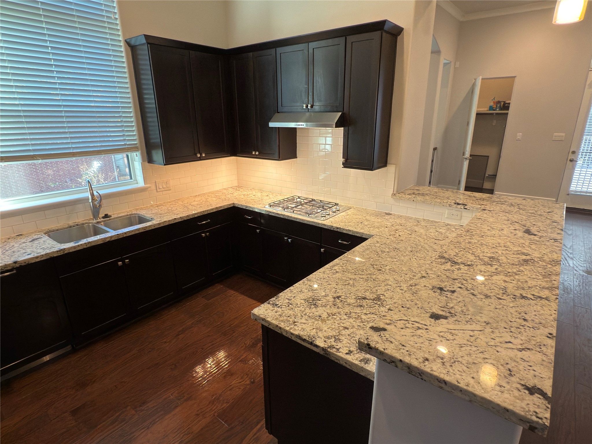 5640 Larkin Street Houston, TX 77007 - Photo 15 of 36 a kitchen with granite countertop wooden cabinets and a granite counter top