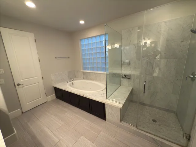 a bathroom with a bathtub and shower
