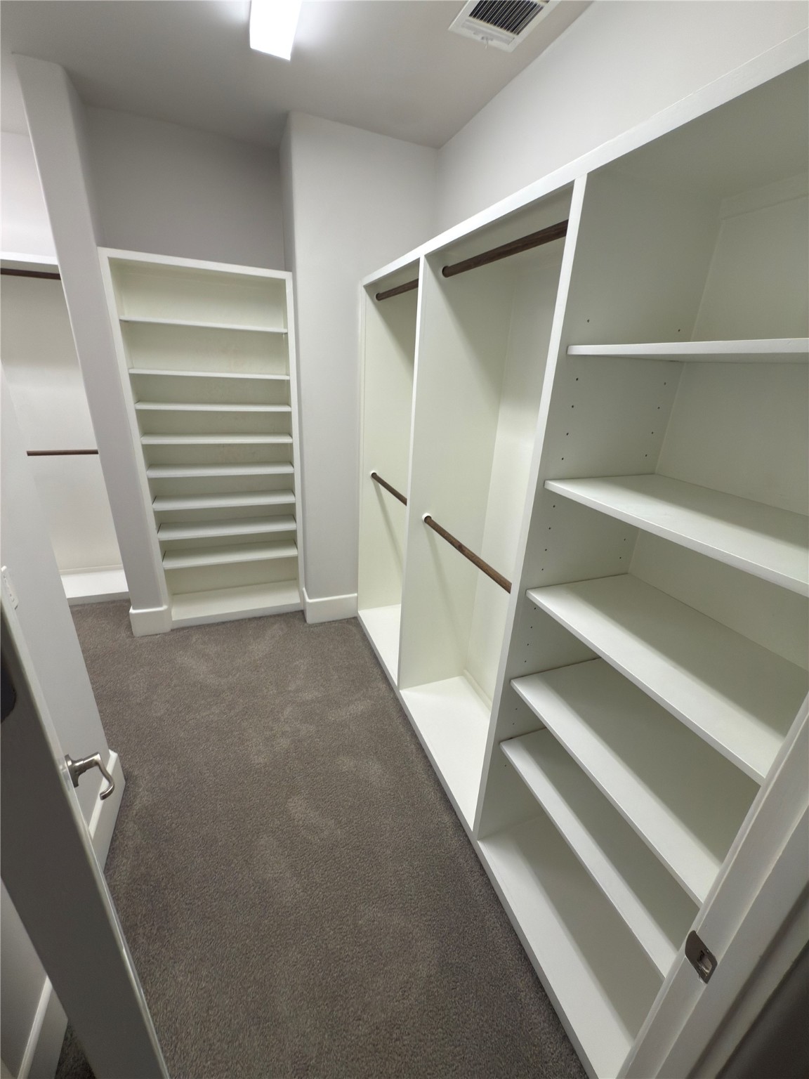 5640 Larkin Street Houston, TX 77007 - Photo 22 of 36 a view of walk in closet with empty racks
