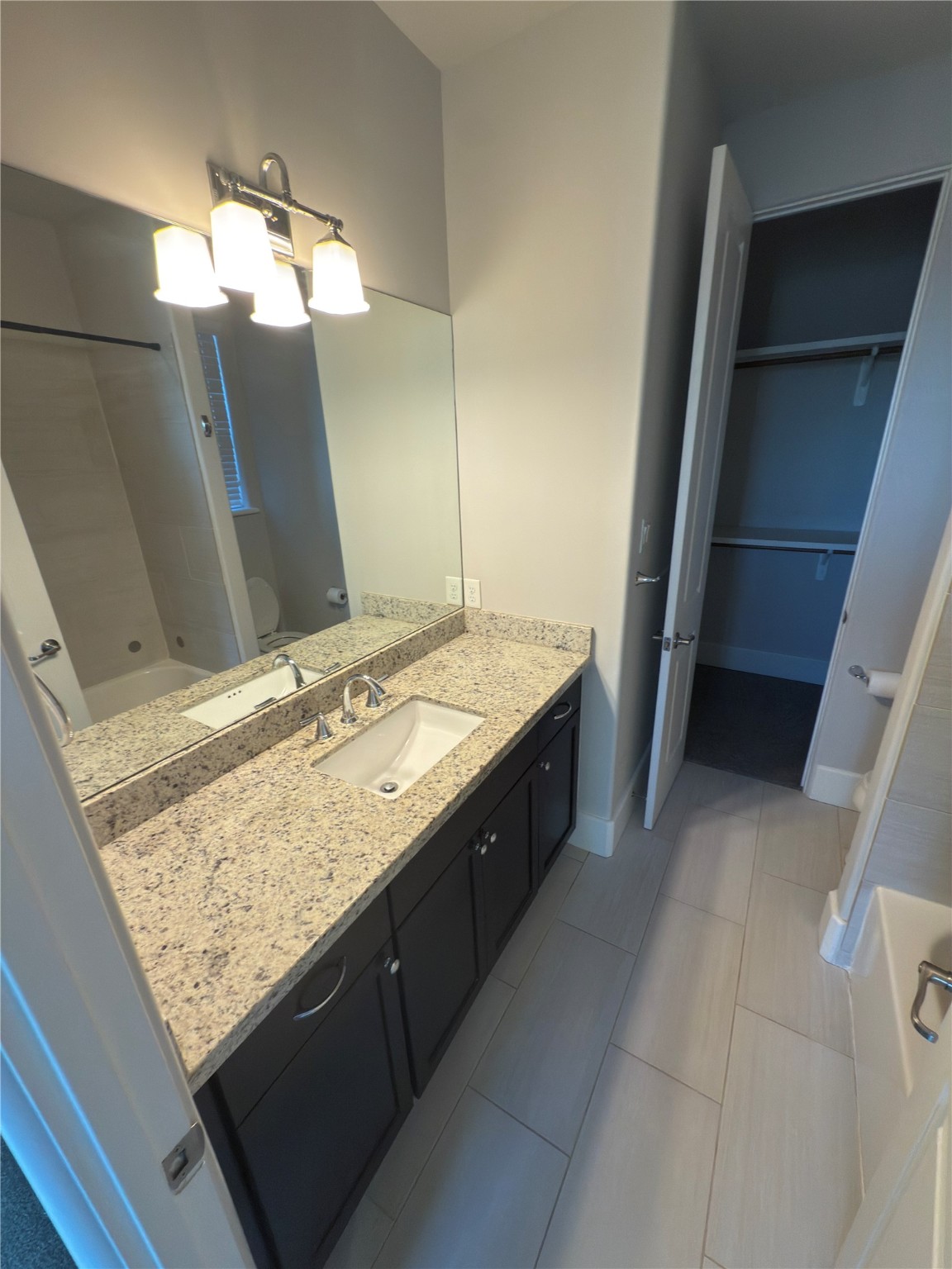 5640 Larkin Street Houston, TX 77007 - Photo 25 of 36 a bathroom with a granite countertop sink and a mirror