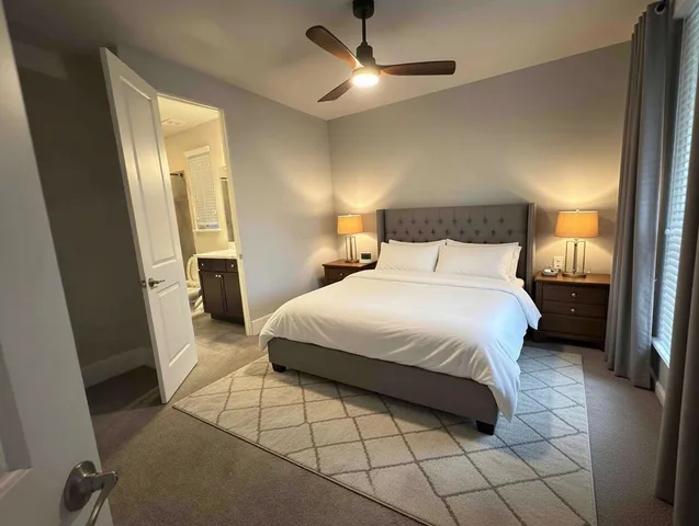 a bedroom with a bed and a lamp