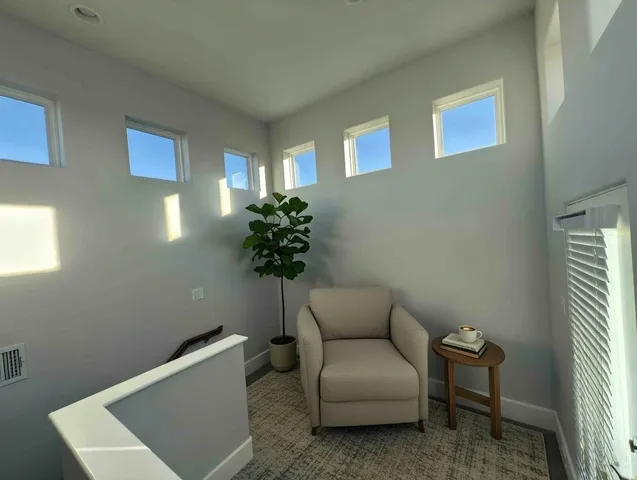 a living room with furniture and a potted plant