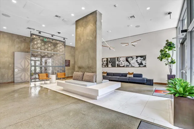 a living room with patio furniture and a potted plant