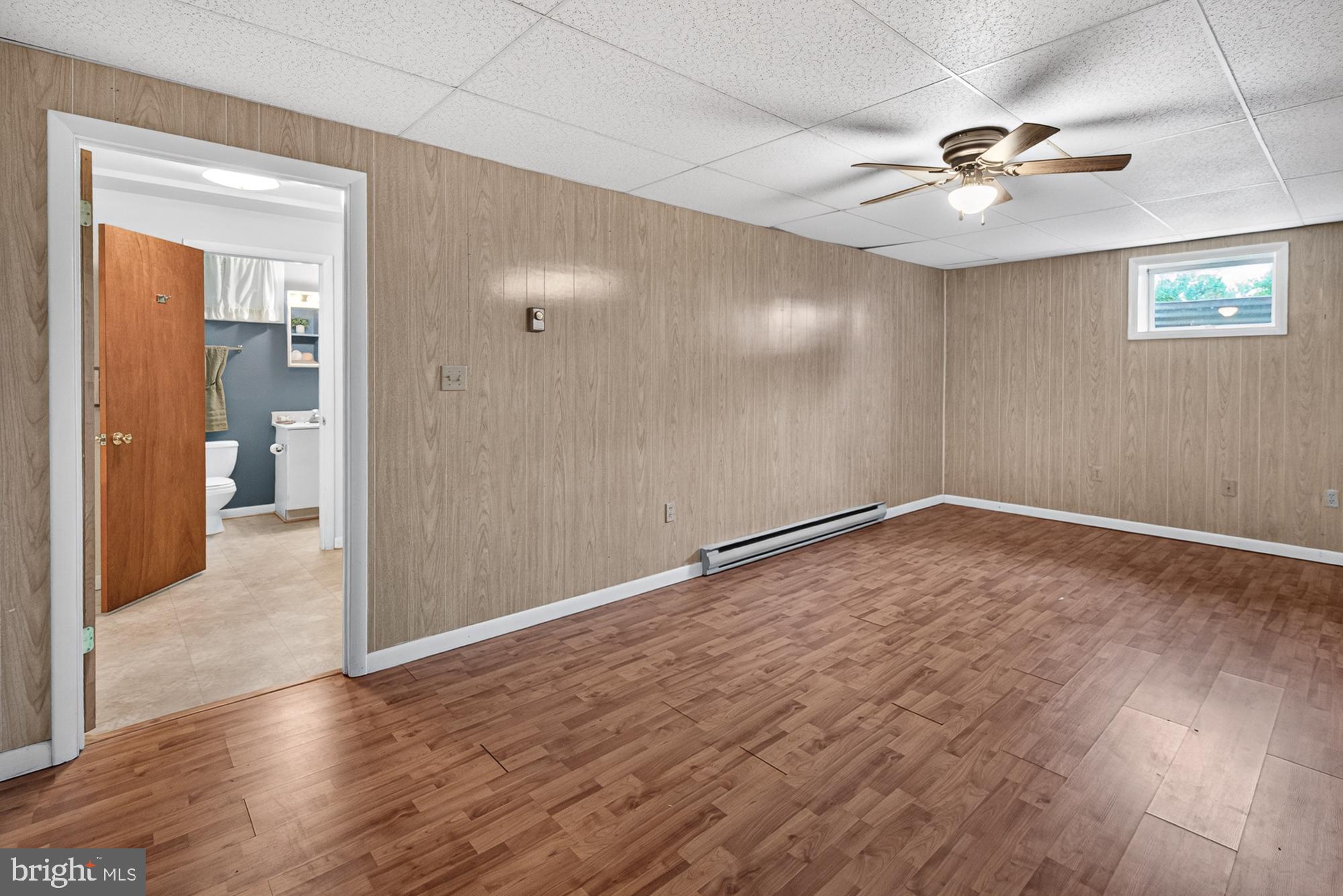 5601 Woodville Road Mount Airy, MD 21771 - Photo 33 of 54 an empty room with wooden floor and a ceiling fan