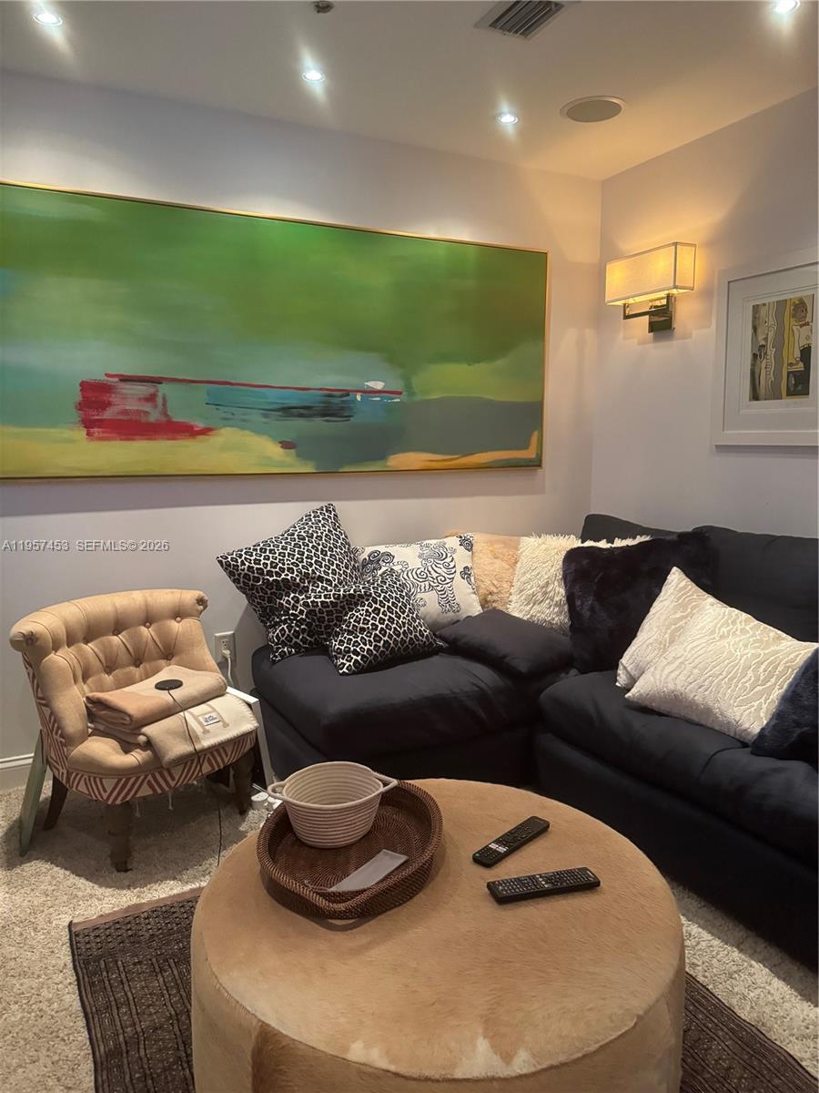 1050 Brickell Avenue, Unit 818 Miami, FL 33131 - Photo 12 of 19 a living room with furniture and a wooden floor