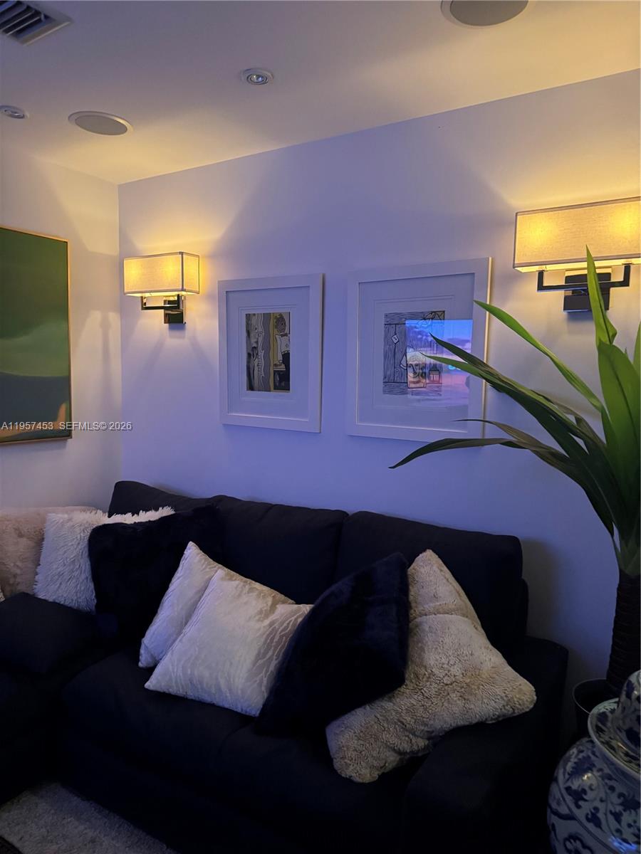 1050 Brickell Avenue, Unit 818 Miami, FL 33131 - Photo 13 of 19 a living room with furniture and a flat screen tv