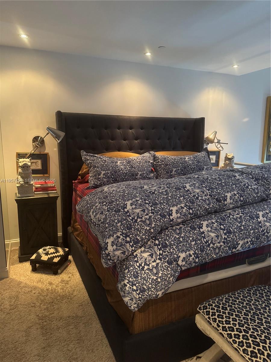 1050 Brickell Avenue, Unit 818 Miami, FL 33131 - Photo 15 of 19 a bed sitting in a room next to a window