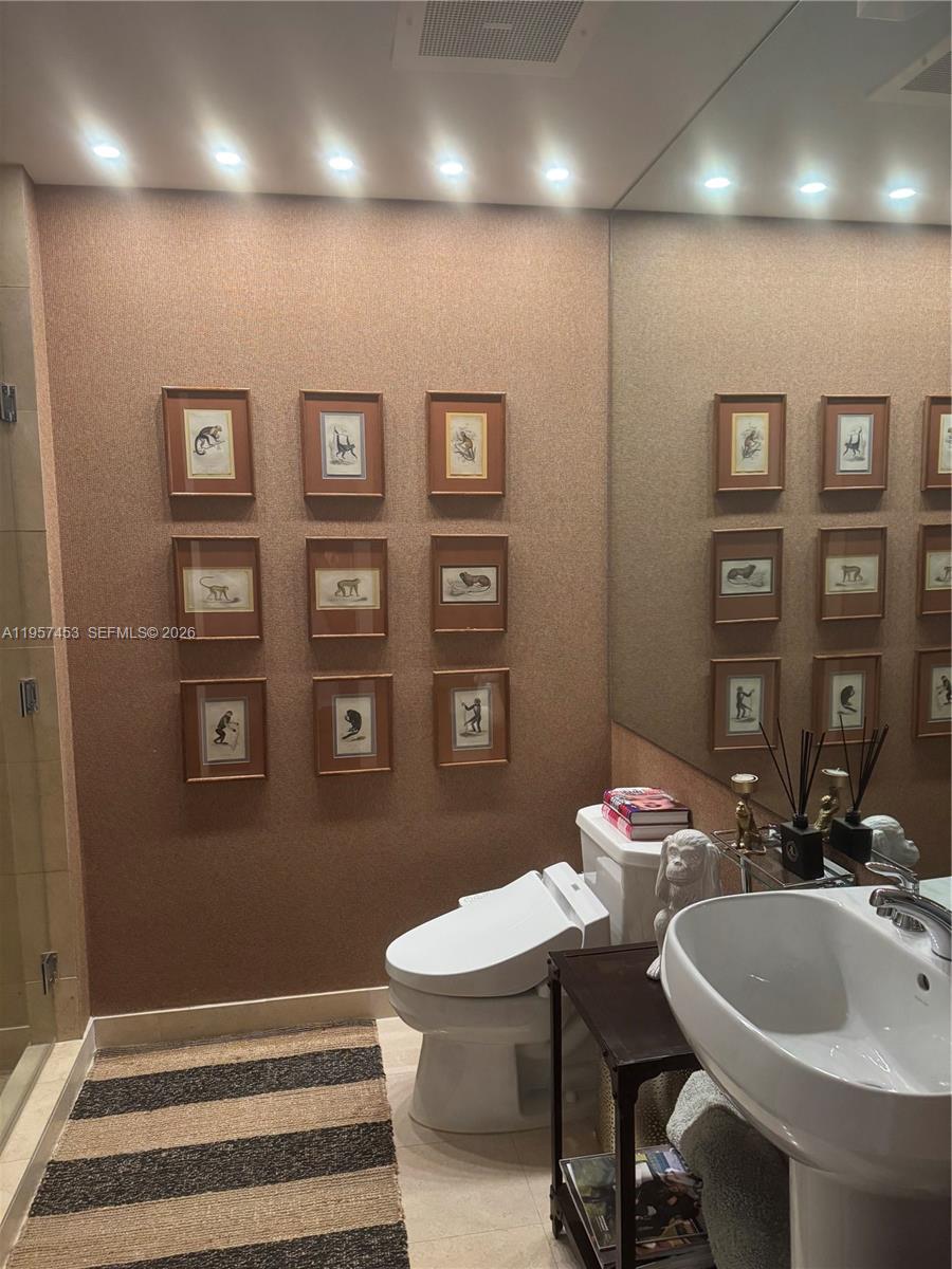 1050 Brickell Avenue, Unit 818 Miami, FL 33131 - Photo 16 of 19 a bathroom with a sink and a mirror