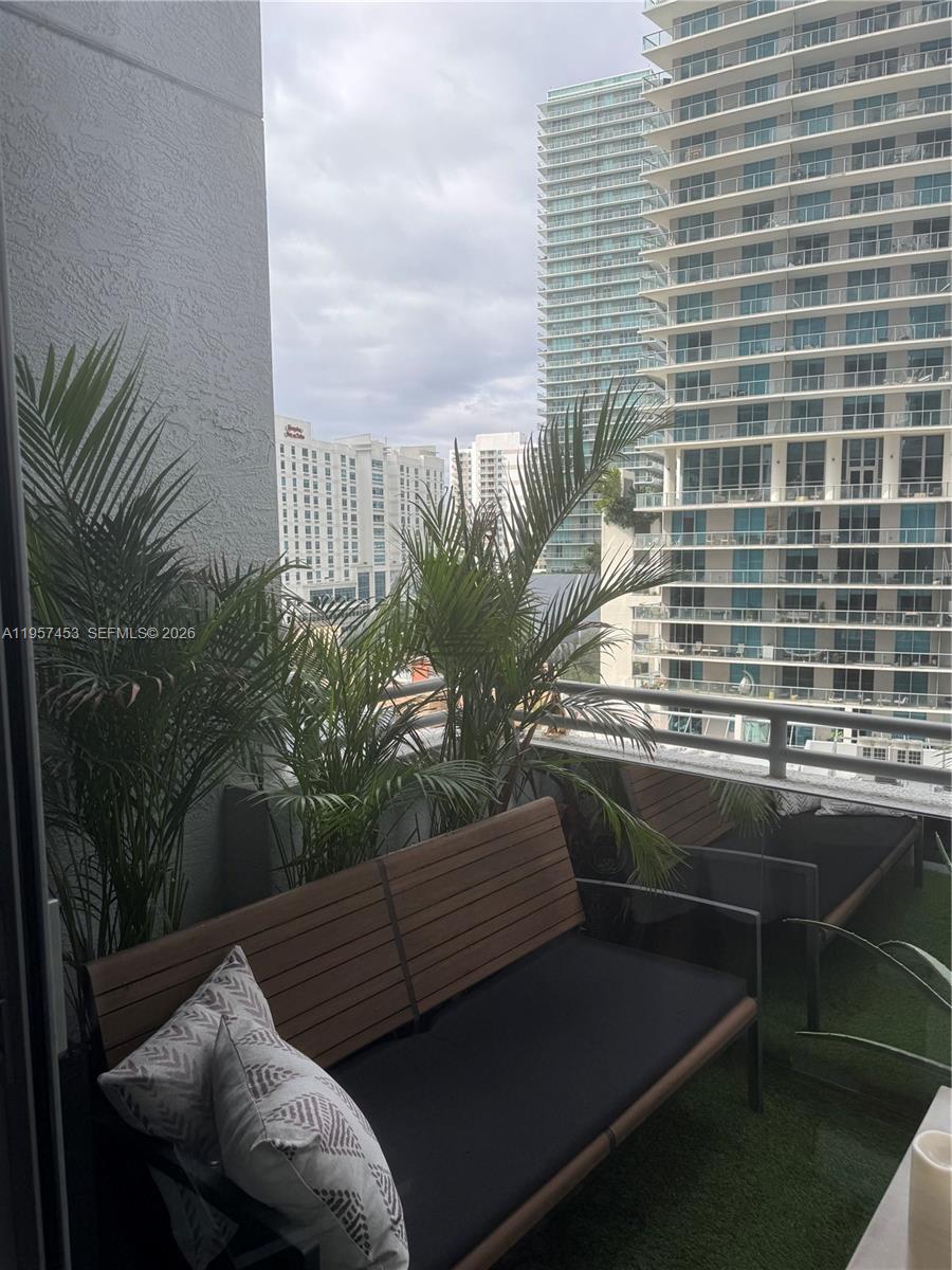1050 Brickell Avenue, Unit 818 Miami, FL 33131 - Photo 2 of 19 a view of balcony with outdoor seating and plants