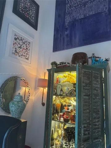 a living room with chairs and a rug