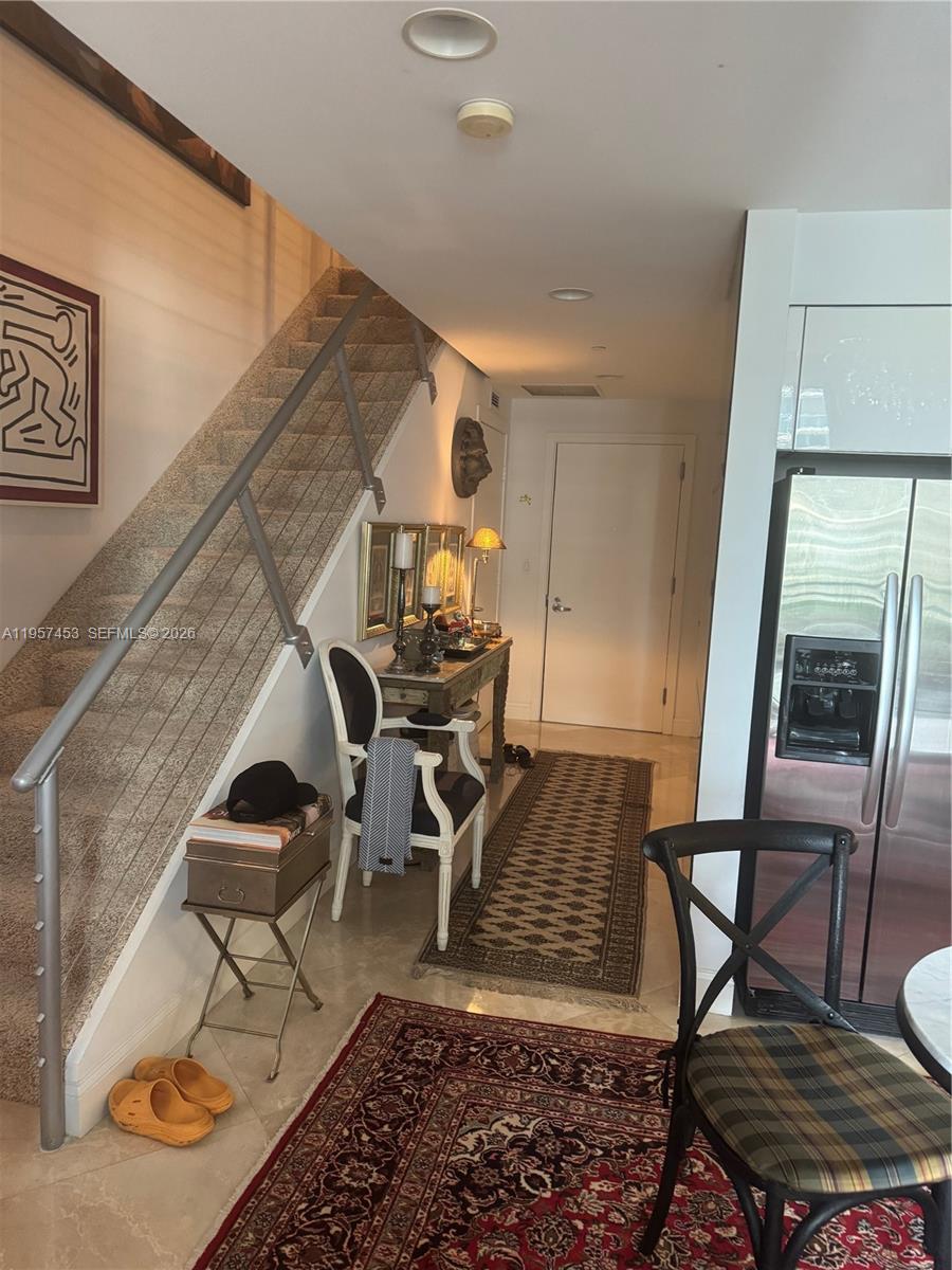 1050 Brickell Avenue, Unit 818 Miami, FL 33131 - Photo 5 of 19 a living room with chairs and a rug