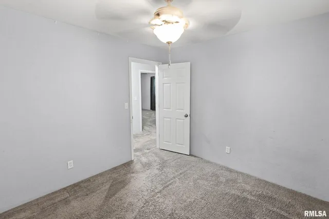 a view of a chandelier fan and hardwood floor