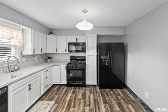 a kitchen with stainless steel appliances granite countertop a sink stove and cabinets