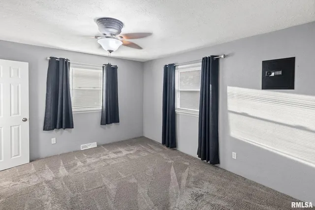 a view of a livingroom with a ceiling fan and window