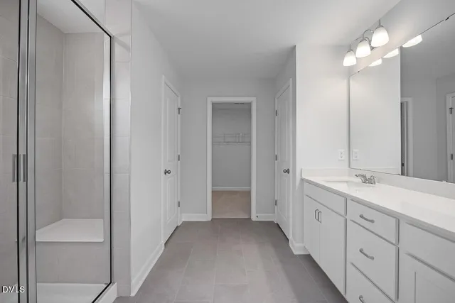a bathroom with a double vanity sink and a mirror