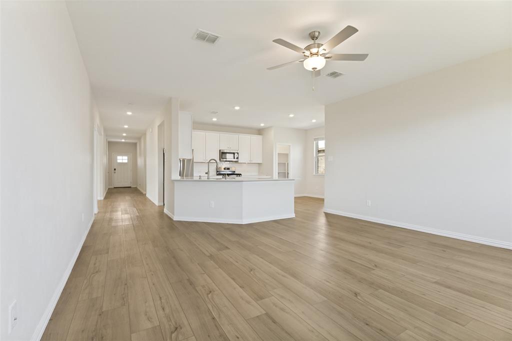 1237 Almond Road Azle, TX 76020 - Photo 4 of 24 a view of a livingroom with a ceiling fan hardwood floor and a ceiling fan