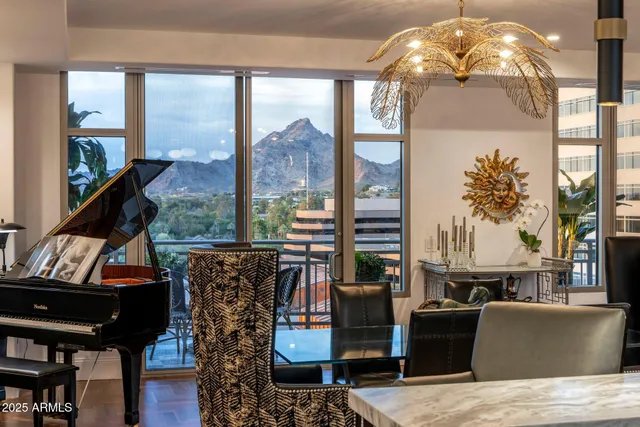 a living room with furniture a rug and a chandelier