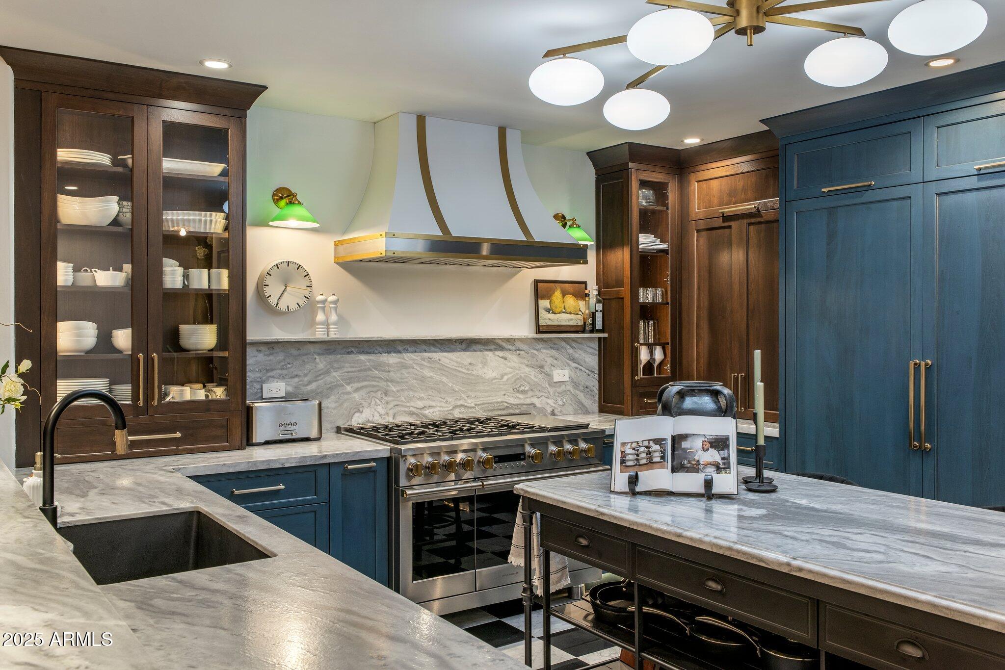 2211 East Camelback Road, Unit 902 Phoenix, AZ 85016 - Photo 11 of 37 a kitchen with stainless steel appliances granite countertop a sink and a stove