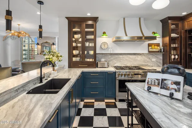 a kitchen with a sink a stove and a wooden floor