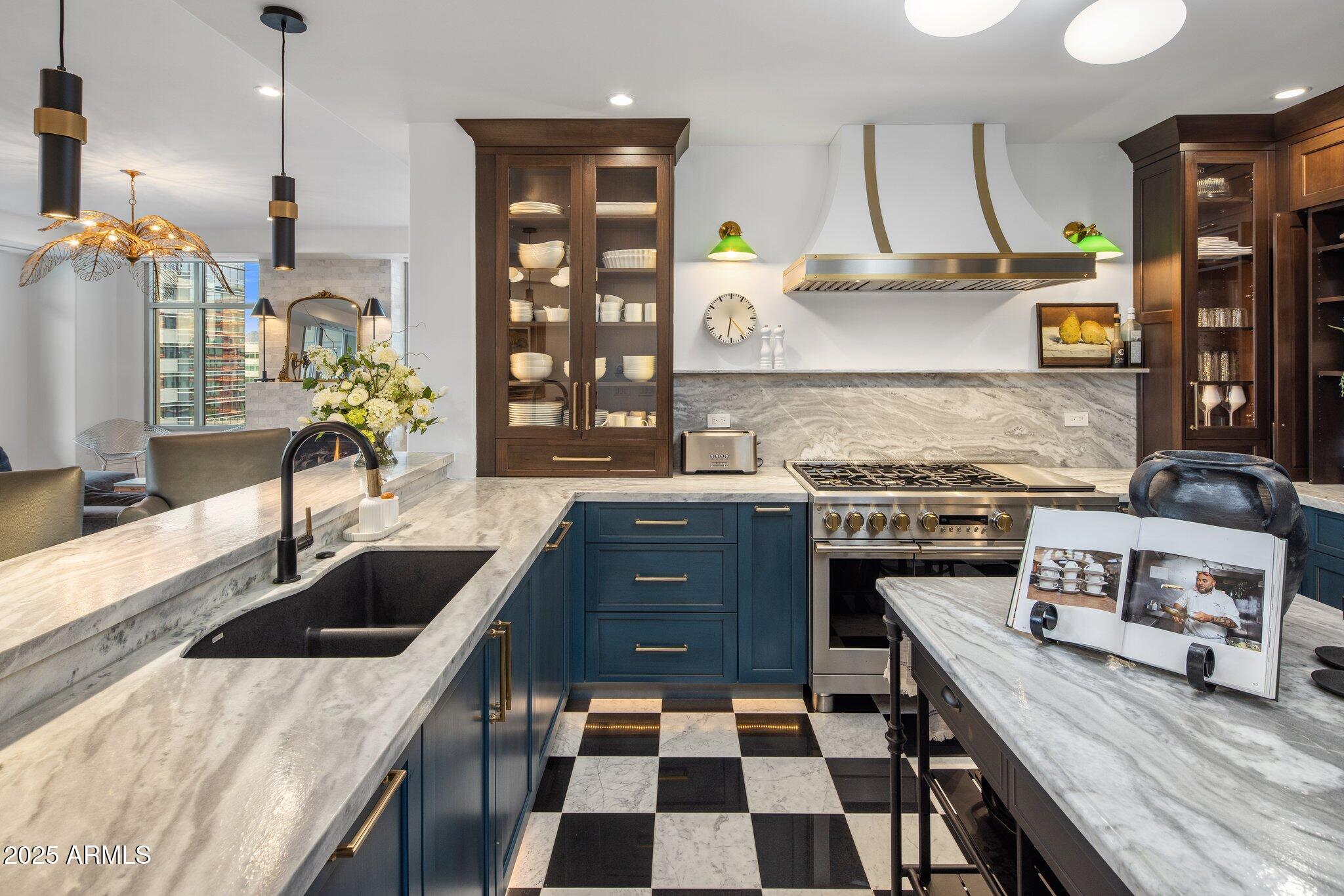 2211 East Camelback Road, Unit 902 Phoenix, AZ 85016 - Photo 13 of 37 a kitchen with a sink a stove and a wooden floor