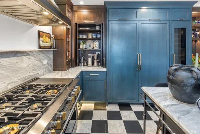 a kitchen with a refrigerator and a stove