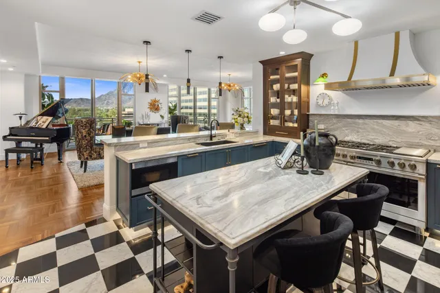 a kitchen with a stove a sink a dining table and chairs