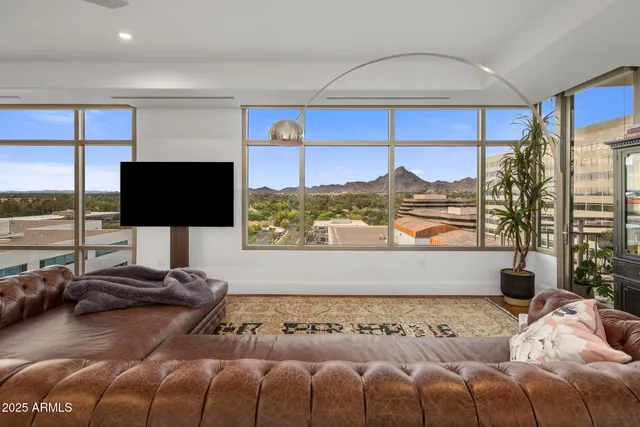 a bedroom with a large bed and a flat tv screen on dresser