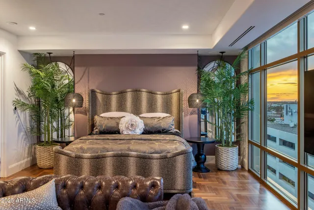 a room with furniture and potted plants