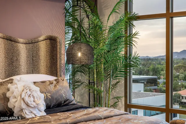 a bedroom with a bed and a potted plant