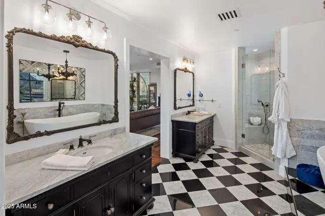 a bathroom with a sink a toilet a mirror and shower