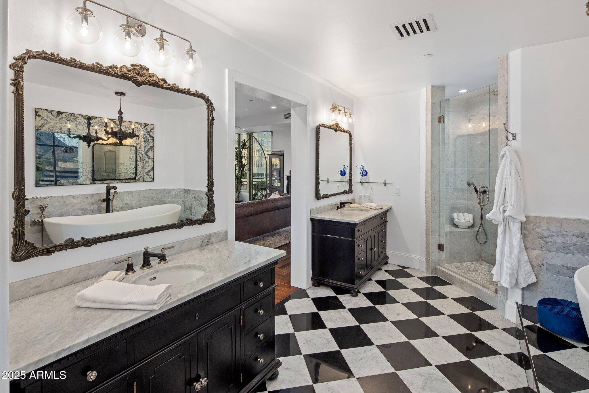 2211 East Camelback Road, Unit 902 Phoenix, AZ 85016 - Photo 22 of 37 a bathroom with a sink a toilet a mirror and shower