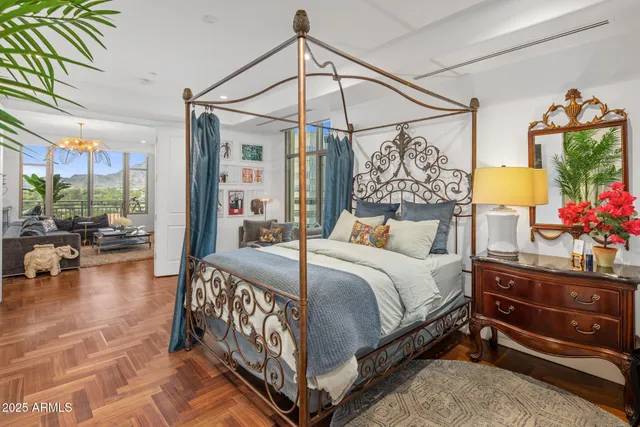 a bedroom with a bed and a chandelier