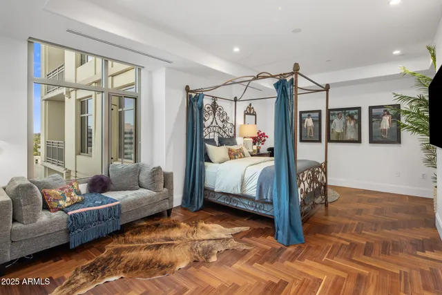 a bedroom with furniture and a large window