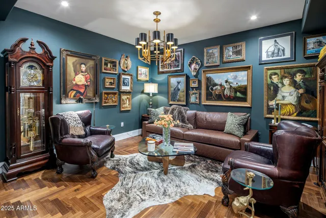 a living room with furniture and a chandelier